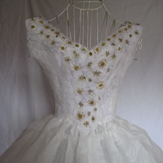 Embroidered white paper dress on wire frame. Embroidery is mixture of yellow cow parsley flower heads and daisies.